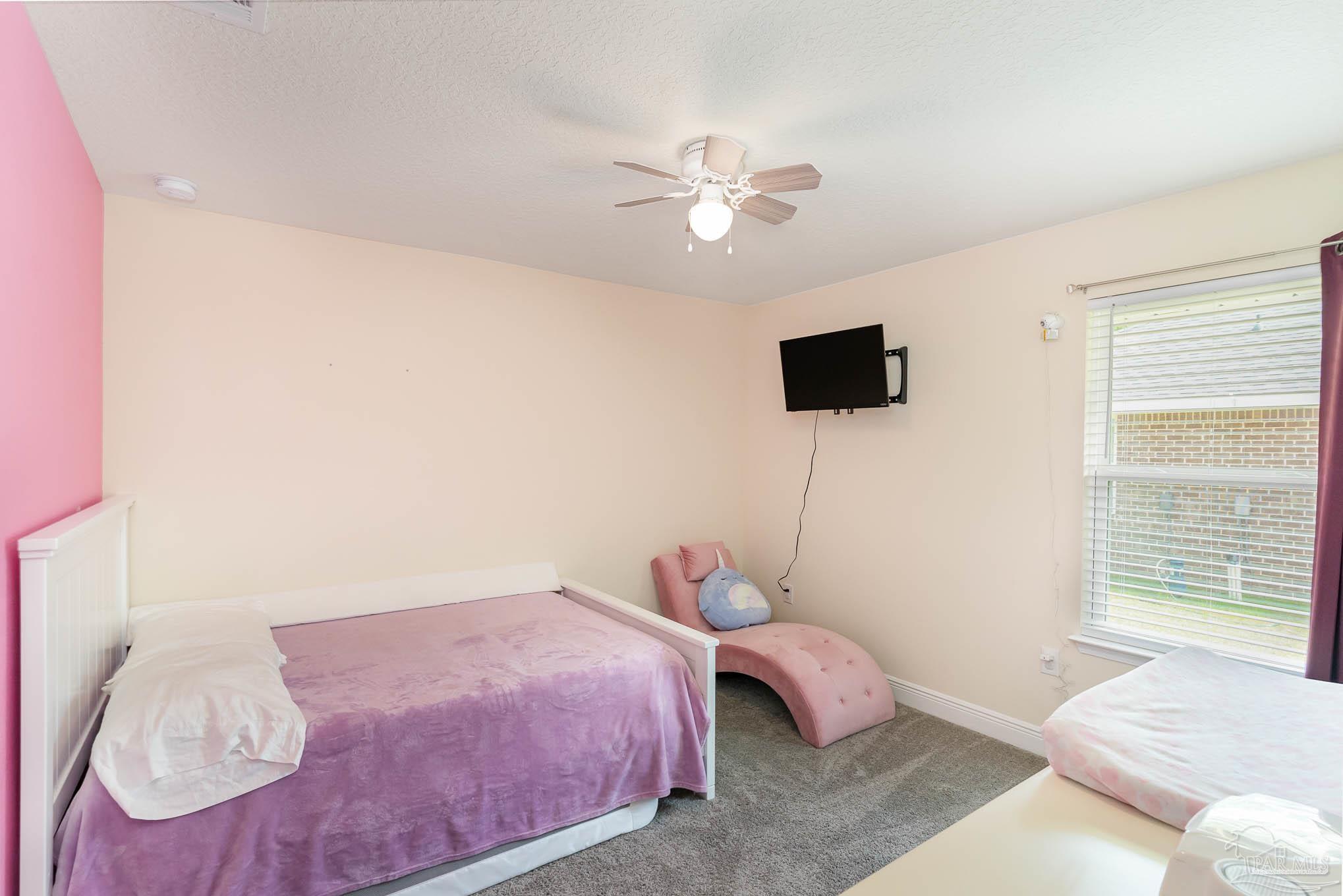 3315 Doyle Hawkins Road Navarre, FL 32566 - Photo 24 of 33 a bedroom with a bed and a window