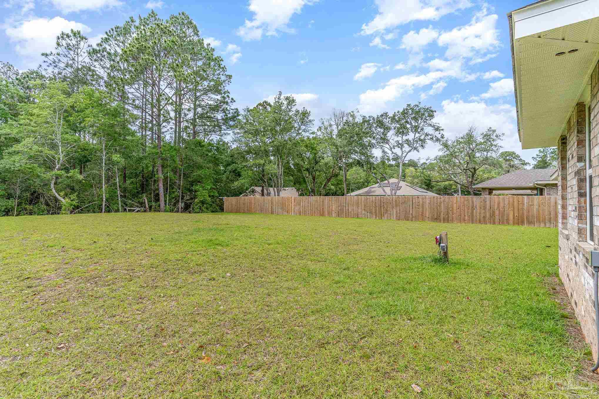3315 Doyle Hawkins Road Navarre, FL 32566 - Photo 28 of 33 a view of a field with grass