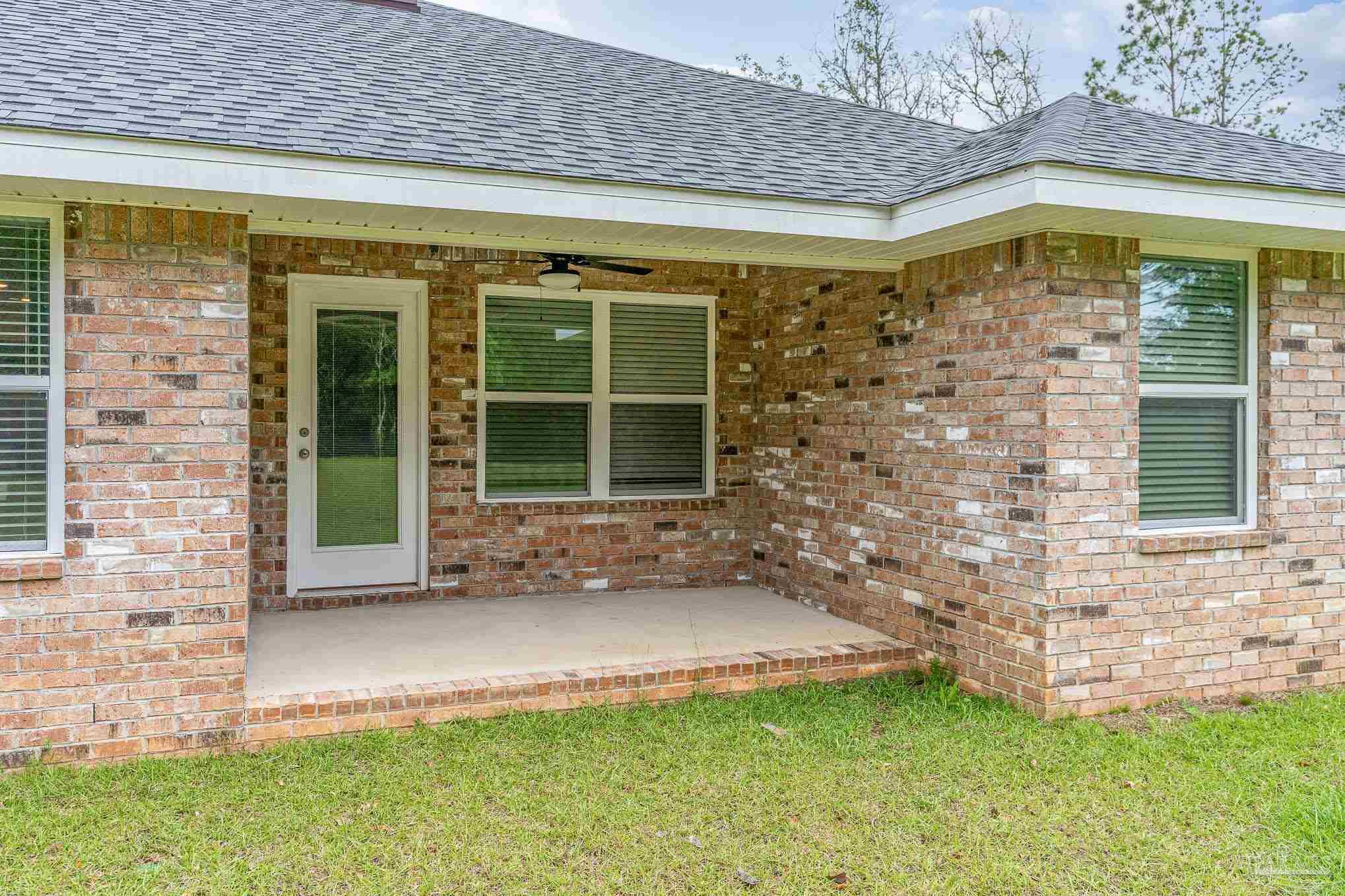 3315 Doyle Hawkins Road Navarre, FL 32566 - Photo 29 of 33 a view of front door of house with a yard