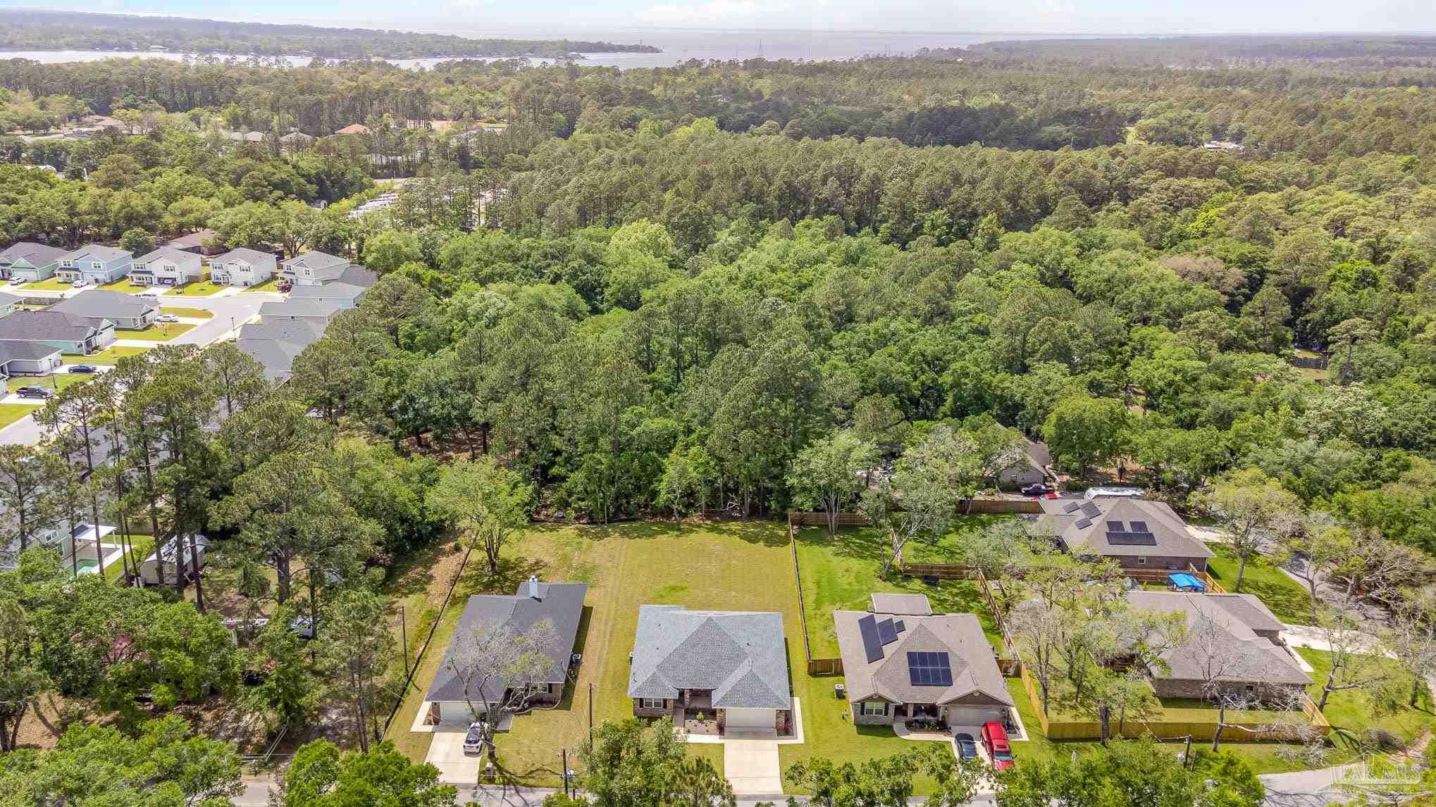 3315 Doyle Hawkins Road Navarre, FL 32566 - Photo 31 of 33 an aerial view of residential houses with outdoor space and trees