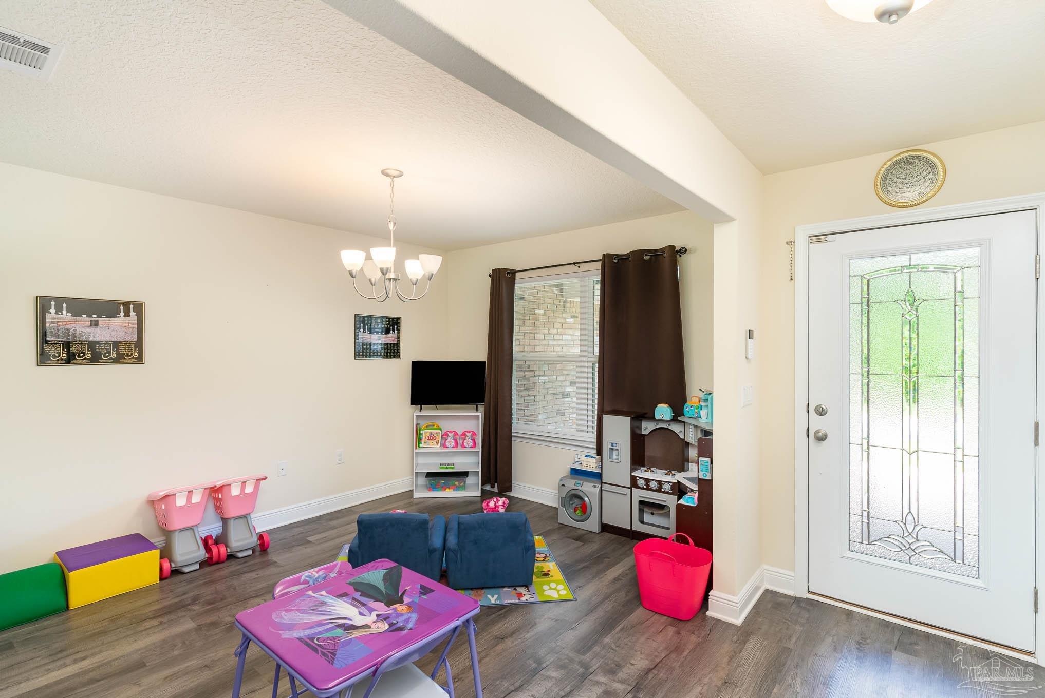 3315 Doyle Hawkins Road Navarre, FL 32566 - Photo 4 of 33 a living room with furniture and a flat screen tv