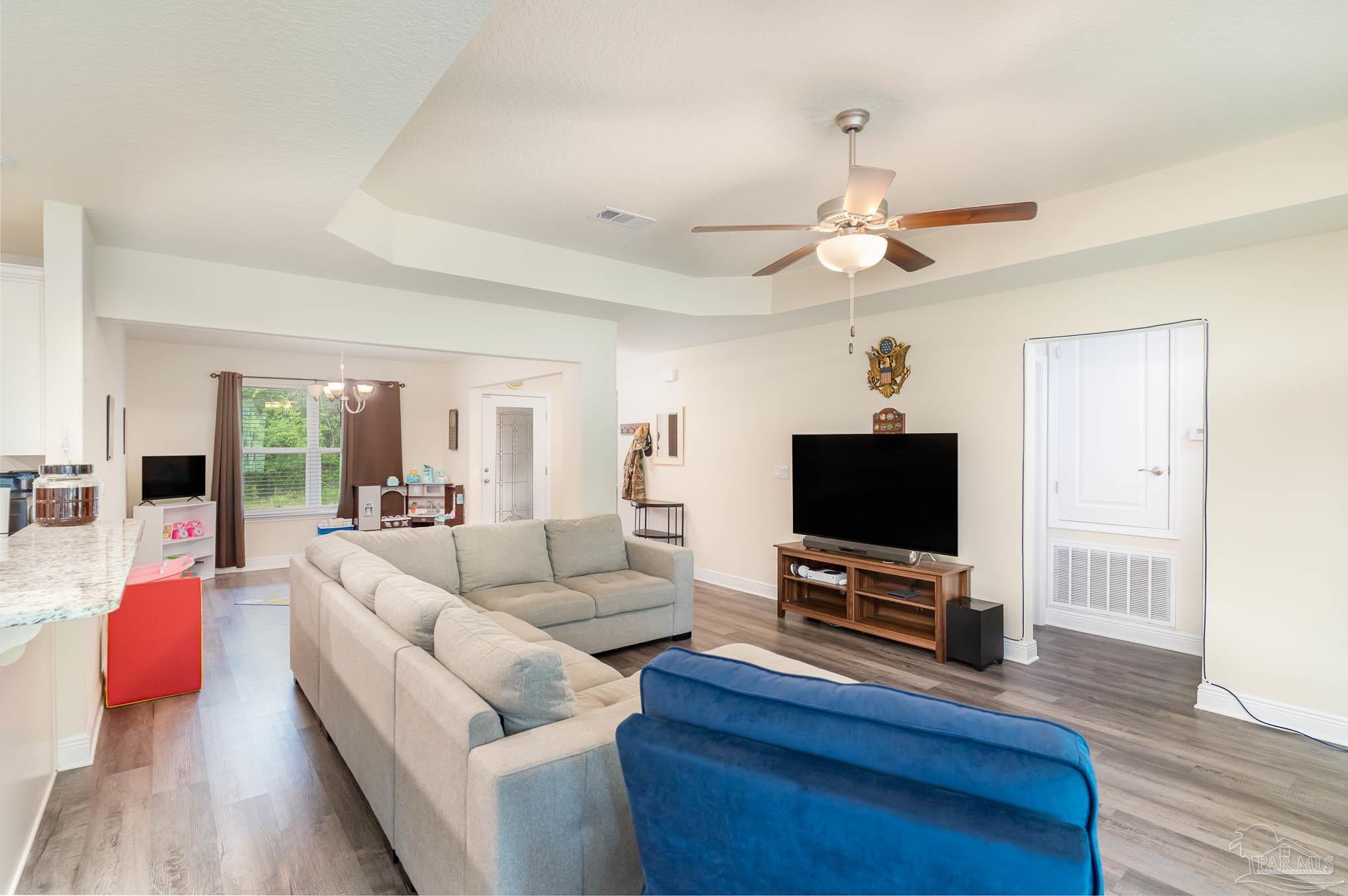 3315 Doyle Hawkins Road Navarre, FL 32566 - Photo 6 of 33 a living room with furniture and a flat screen tv