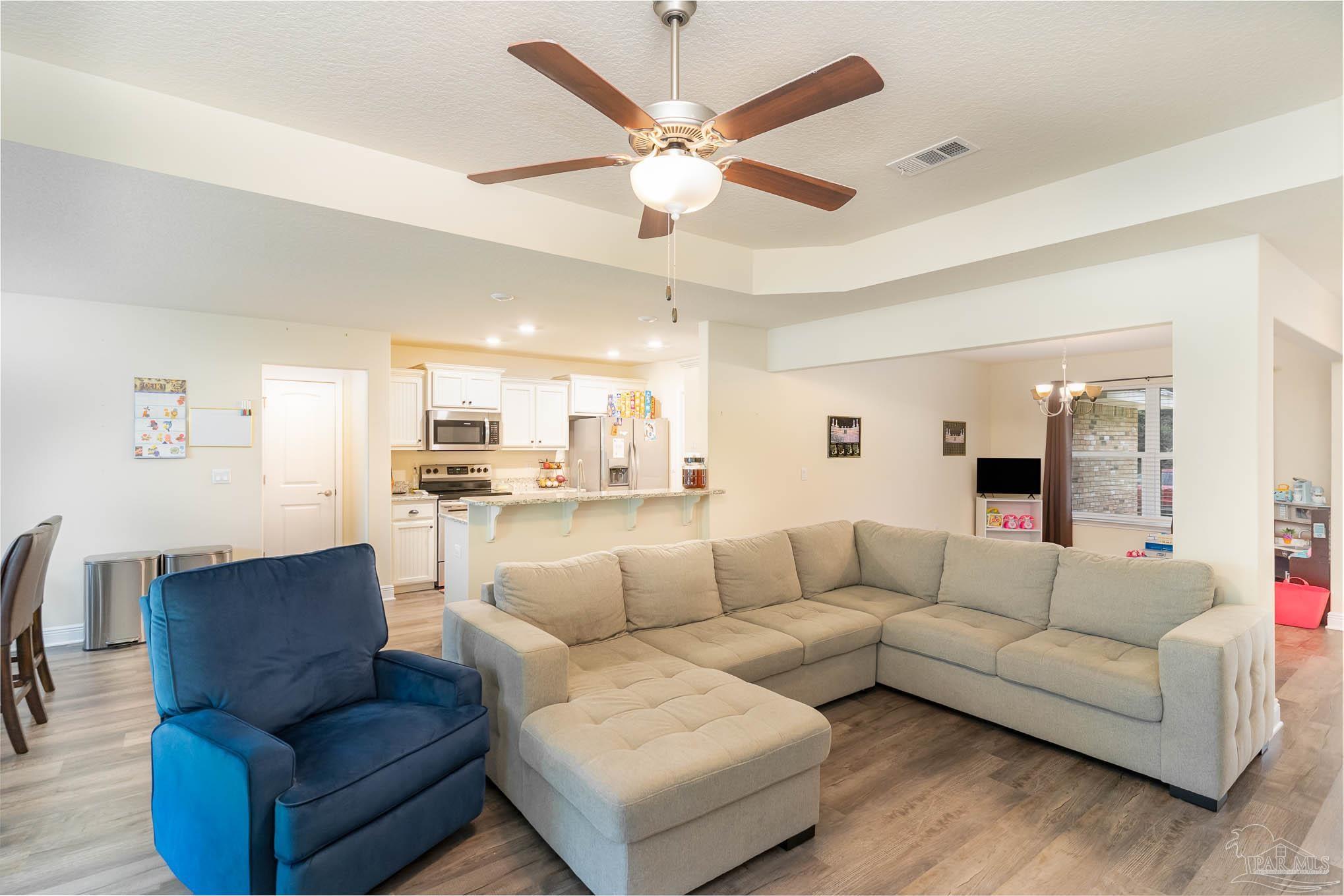 3315 Doyle Hawkins Road Navarre, FL 32566 - Photo 7 of 33 a living room with furniture and view of kitchen