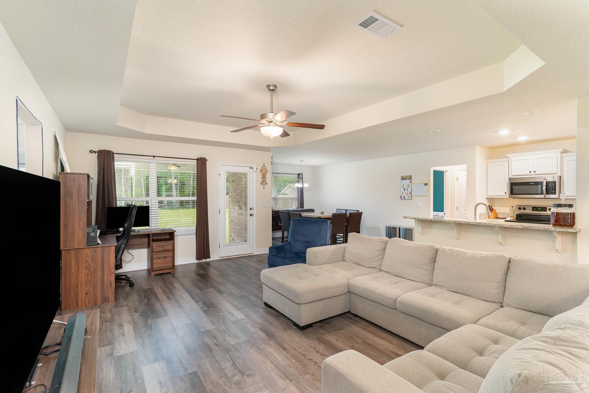 3315 Doyle Hawkins Road Navarre, FL 32566 - Photo 8 of 33 a living room with furniture and a flat screen tv