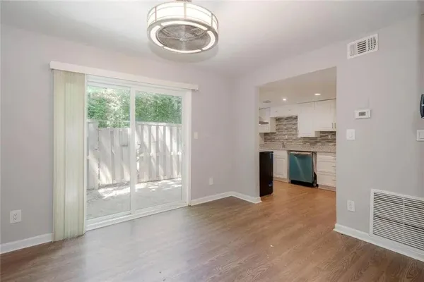 a open kitchen with a sink dishwasher stove top oven and cabinets