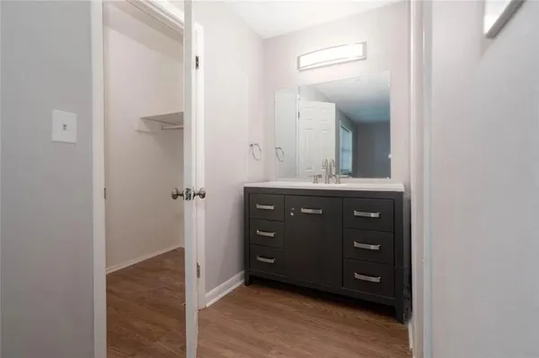 a bathroom with a granite countertop sink a mirror and a vanity