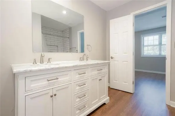 a bathroom with a granite countertop sink mirror and