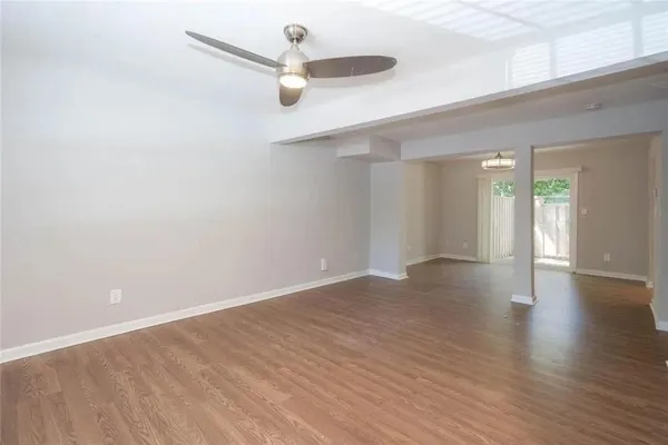 a view of an empty room with wooden floor