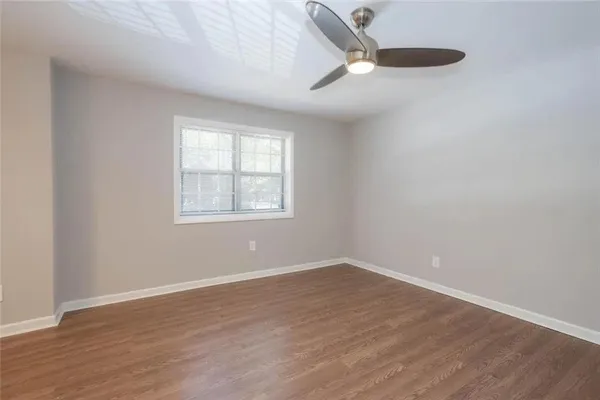 wooden floor in an empty room with a window