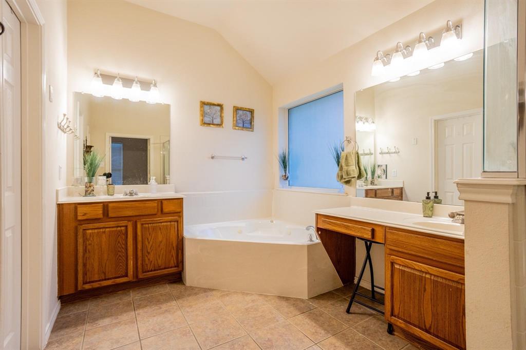 5886 Cliff Ridge Drive Dallas, TX 75249 - Photo 9 of 15 a spacious bathroom with a tub sink and mirror