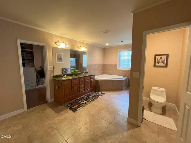 a large bathroom with a large tub and sink