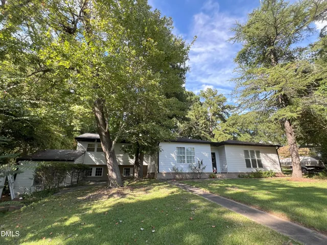 a view of a couches in front of house with a yard