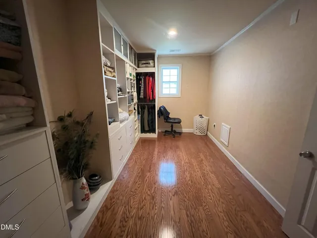 a view of hallway with wooden floor and stairs