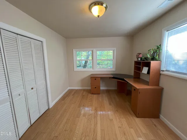 wooden floor chandelier and windows in a room