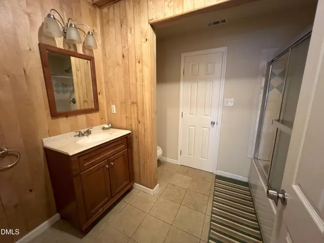 a bathroom with a shower and a sink