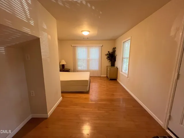 a bedroom with a bed and a potted plant