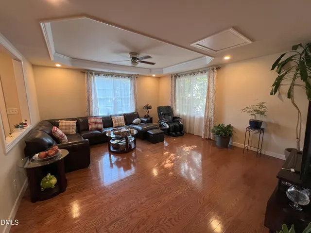 a living room with furniture and a potted plant