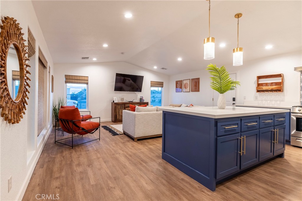 a spacious bedroom with a bed and wooden floor