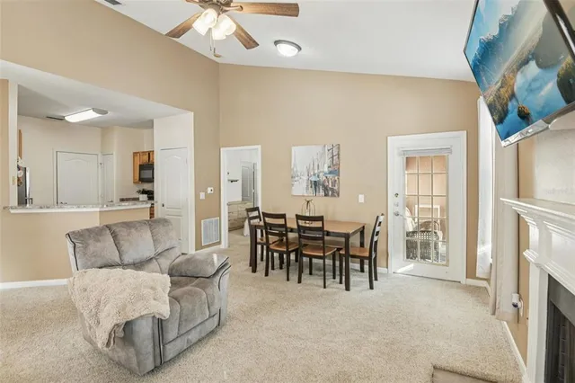 a living room with furniture a fireplace and a chandelier