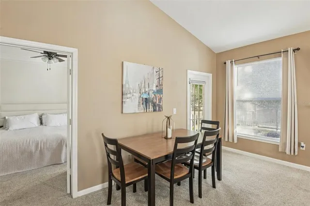 a view of a dining room with furniture and a window
