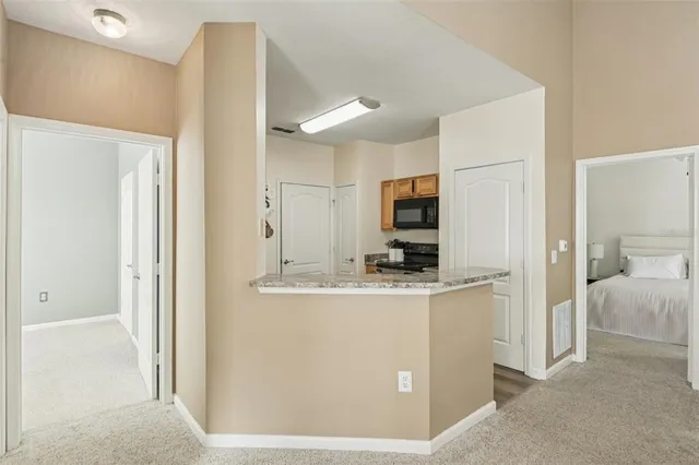 a kitchen with stainless steel appliances a refrigerator a stove a microwave a sink and dishwasher