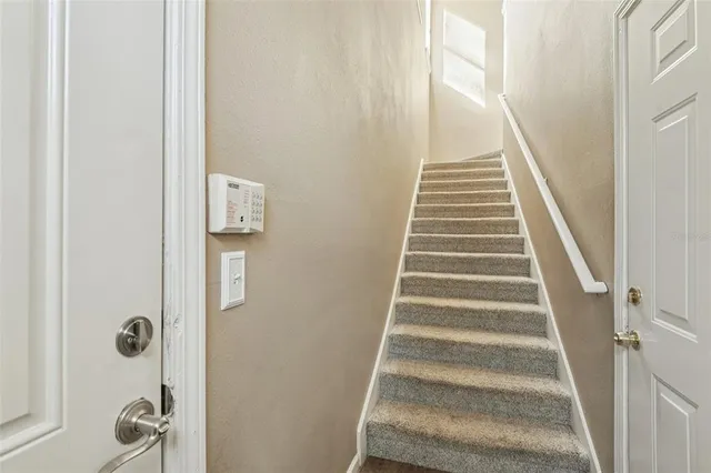 a view of staircase with white walls