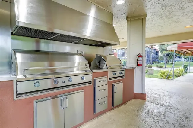 a stove top oven sitting inside of a kitchen