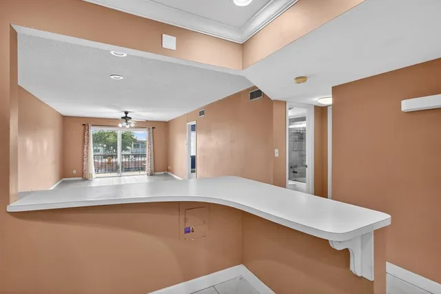 a view of a kitchen with a large window