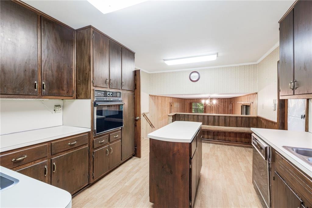 1911 Alderbrook Road Northeast Atlanta, GA 30345 - Photo 12 of 33 a kitchen with granite countertop wooden cabinets and stainless steel appliances