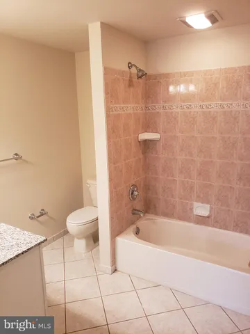 a bathroom with a bathtub and a toilet