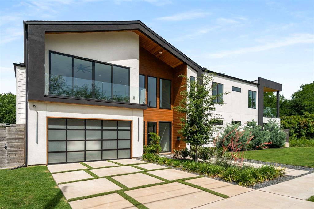 7805 Taos Road Dallas, TX 75209 - Photo 1 of 1 Modern home featuring driveway, stucco siding, a garage, and a front yard