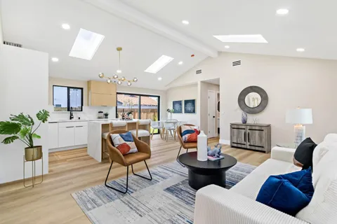 a living room with fireplace furniture and a wooden floor