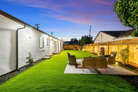 a view of a backyard with plants and a garden