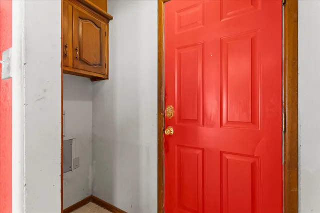 an empty room with closet and fan