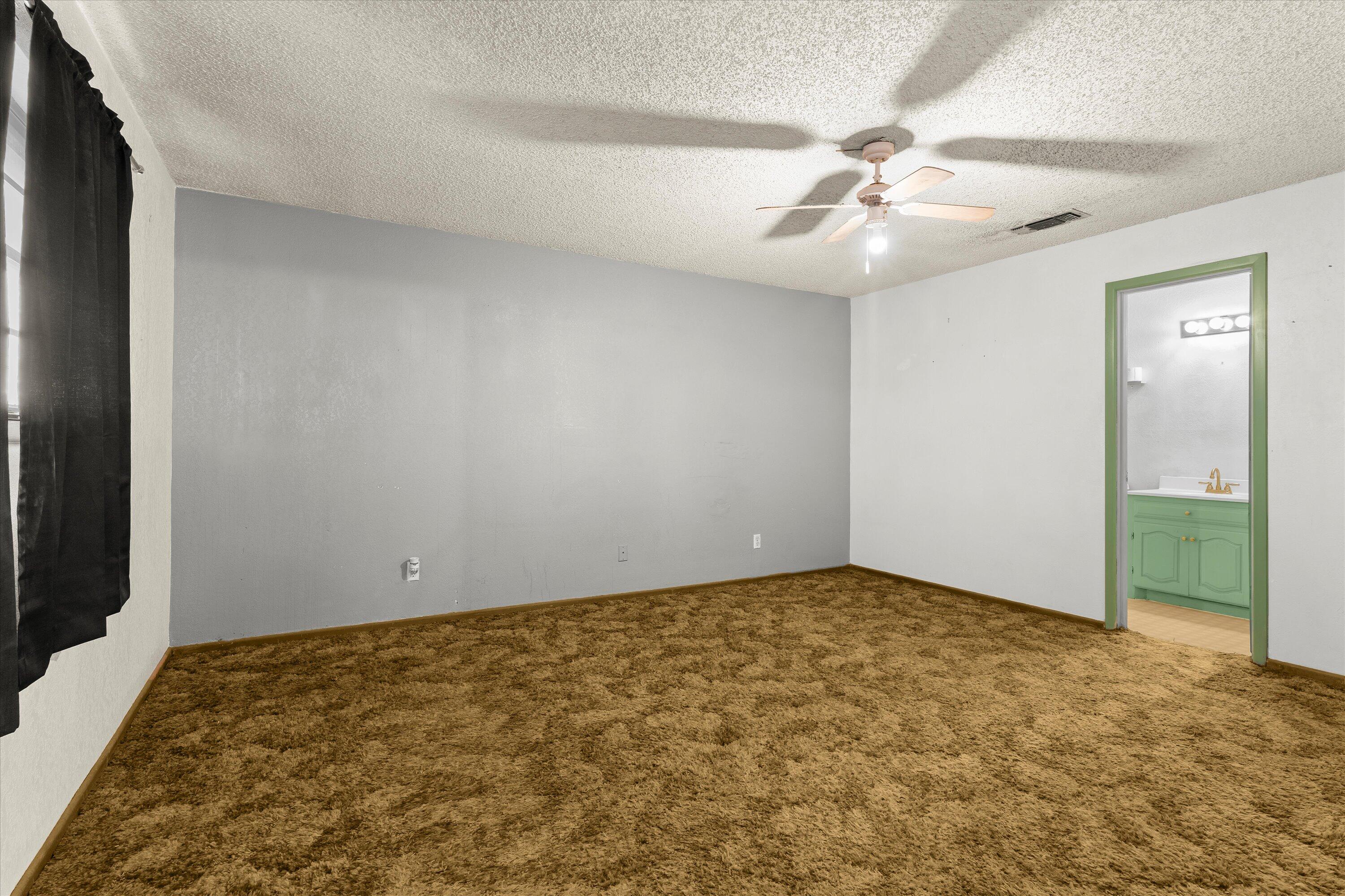 102 Eagle Avenue Levelland, TX 79336 - Photo 12 of 23 an empty room with closet and fan