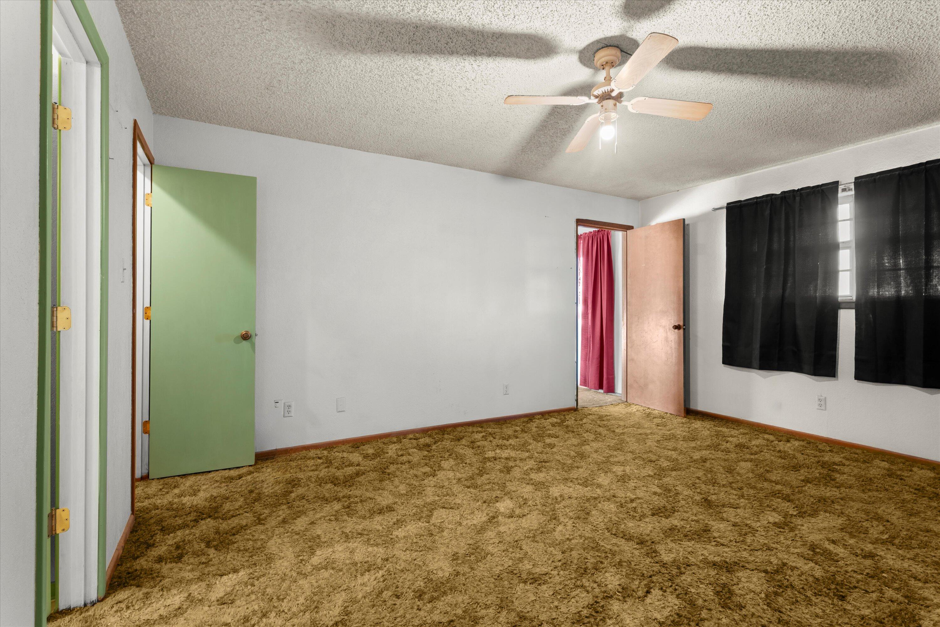 102 Eagle Avenue Levelland, TX 79336 - Photo 13 of 23 an empty room with fan and hallway