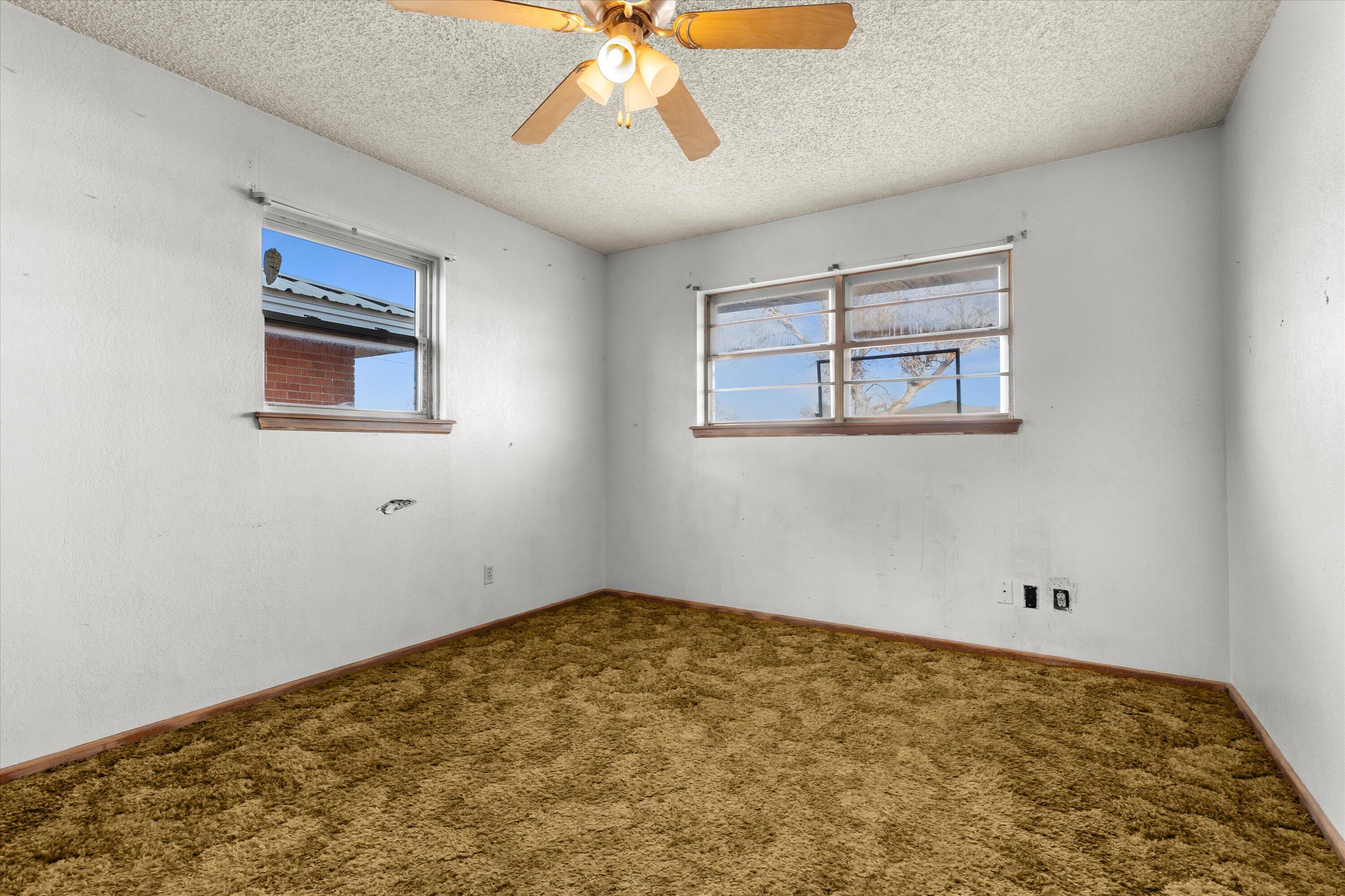 102 Eagle Avenue Levelland, TX 79336 - Photo 20 of 23 a view of room with window and ceiling fan