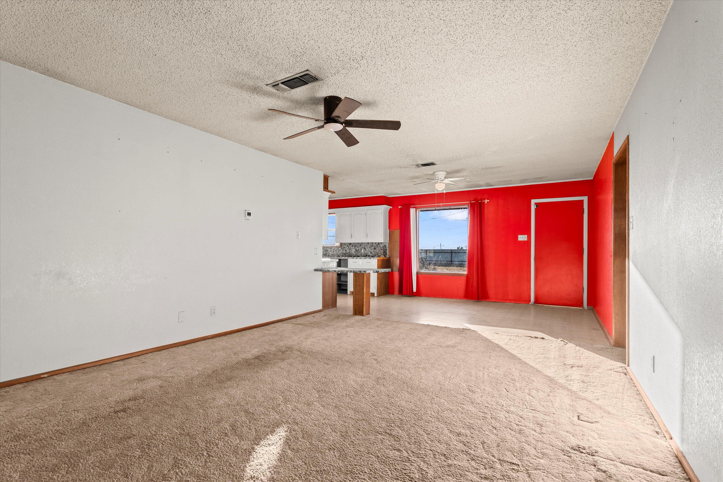102 Eagle Avenue Levelland, TX 79336 - Photo 5 of 23 a view of empty room with window and ceiling fan