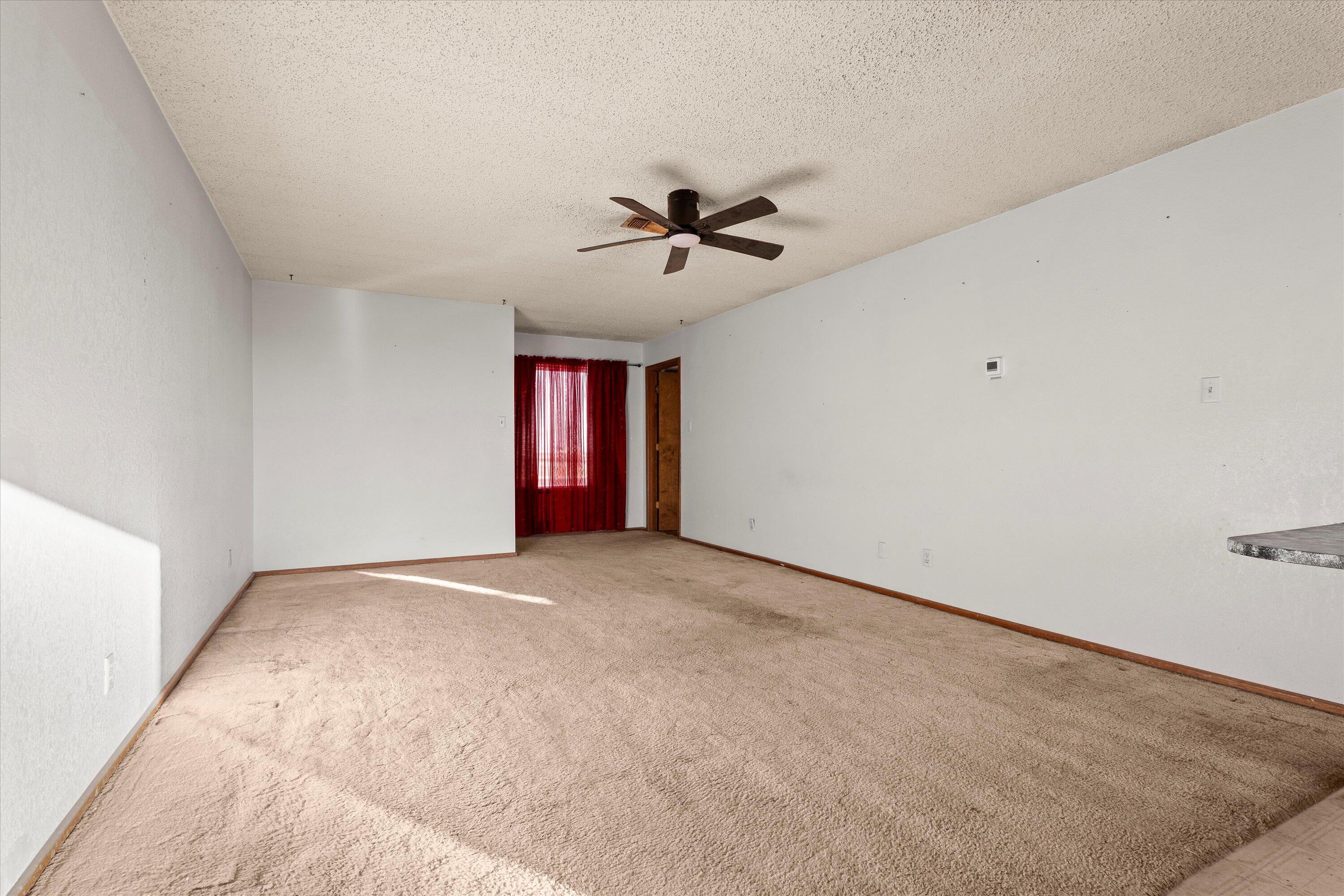 102 Eagle Avenue Levelland, TX 79336 - Photo 6 of 23 a view of an empty room with a ceiling fan