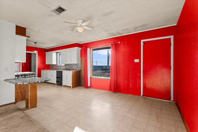 a view of kitchen with stainless steel appliances granite countertop a stove and a refrigerator