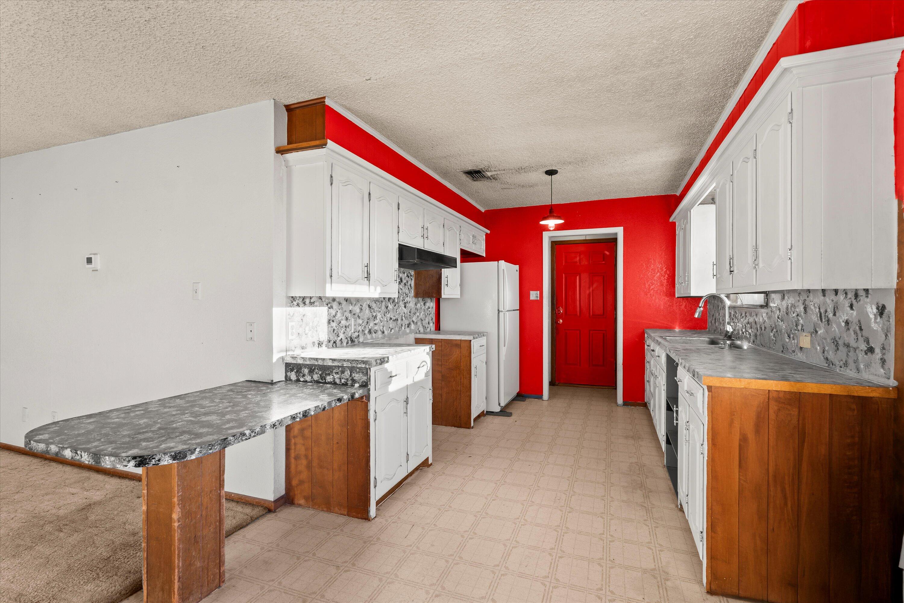 102 Eagle Avenue Levelland, TX 79336 - Photo 9 of 23 a kitchen with stainless steel appliances granite countertop a stove oven and a refrigerator