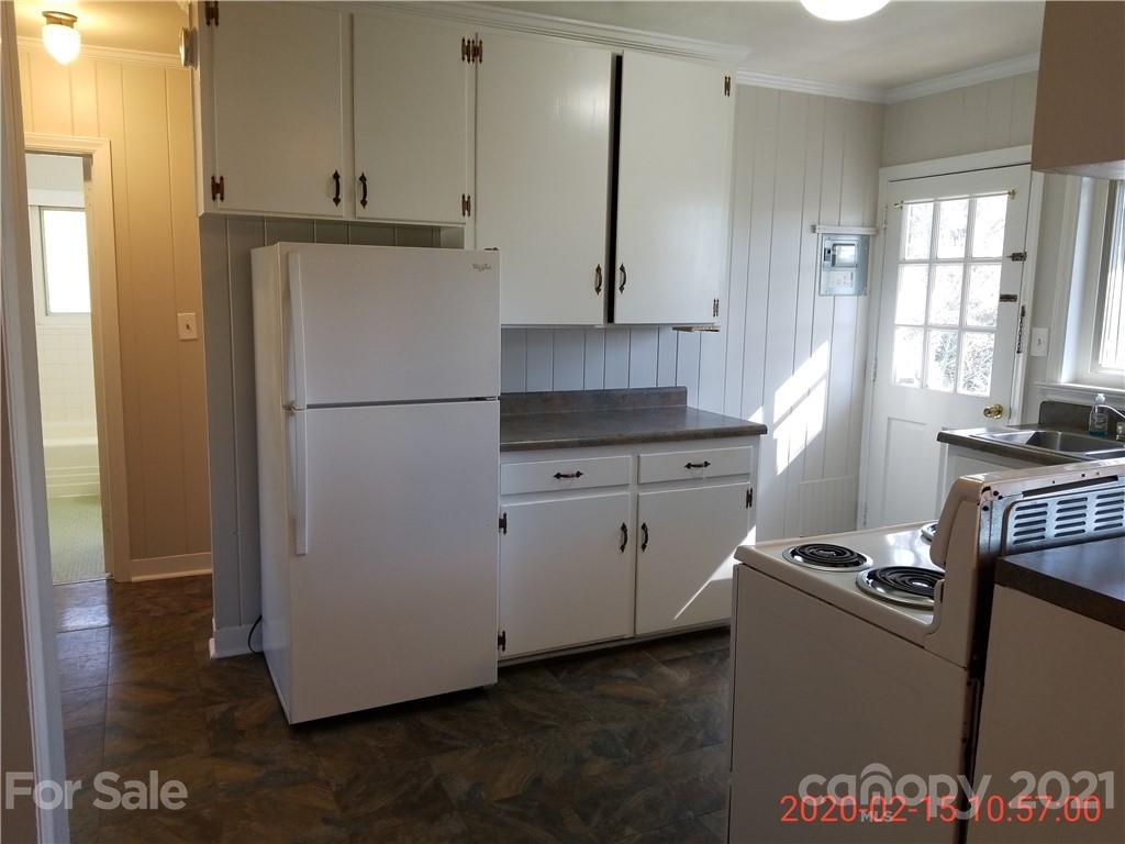 2128 North Sharon Amity Road Charlotte, NC 28212 - Photo 12 of 15 a kitchen with a refrigerator and a stove top oven