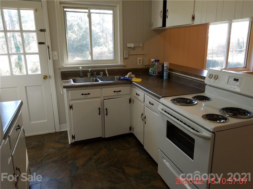 2128 North Sharon Amity Road Charlotte, NC 28212 - Photo 13 of 15 a kitchen with granite countertop a sink stove and cabinets