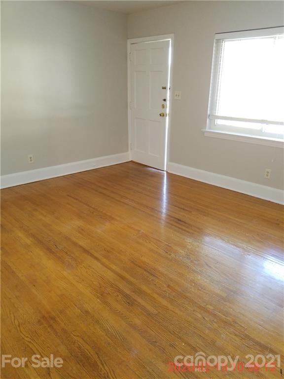 2128 North Sharon Amity Road Charlotte, NC 28212 - Photo 14 of 15 an empty room with wooden floor and windows