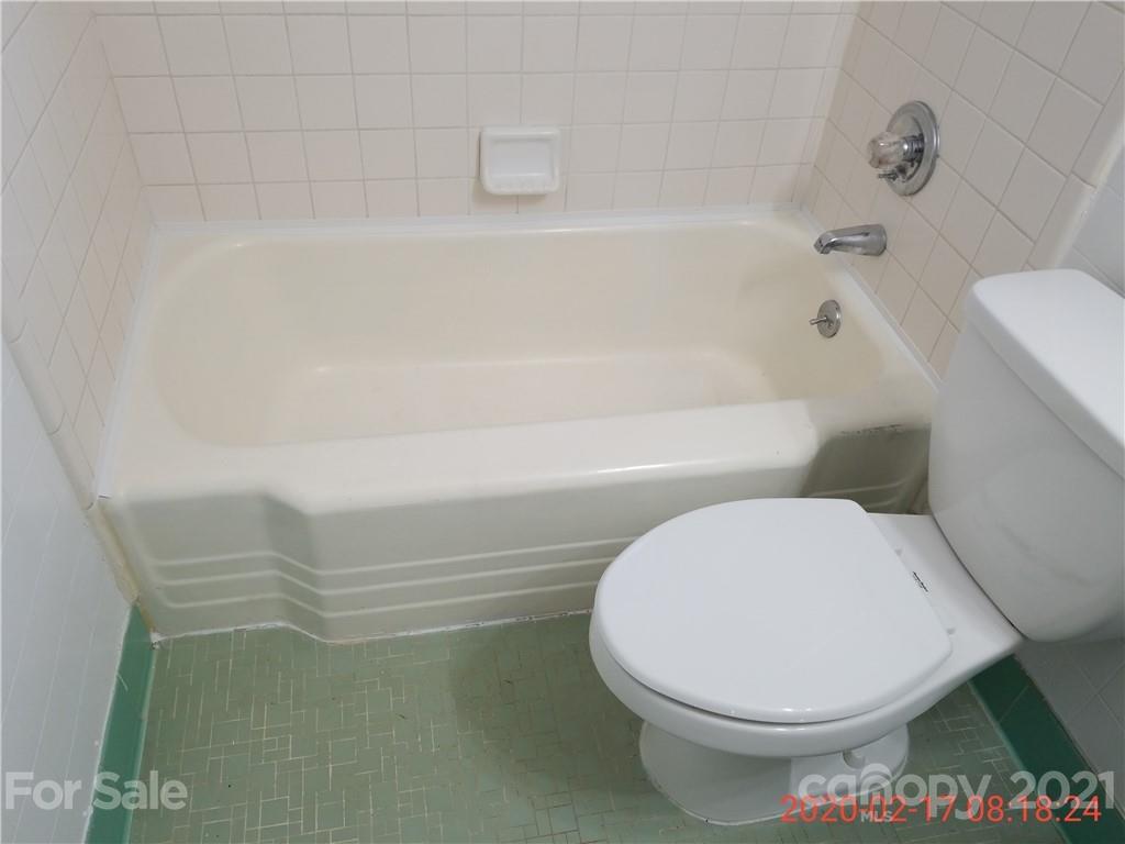 2128 North Sharon Amity Road Charlotte, NC 28212 - Photo 15 of 15 a bathroom with a toilet and a bathtub