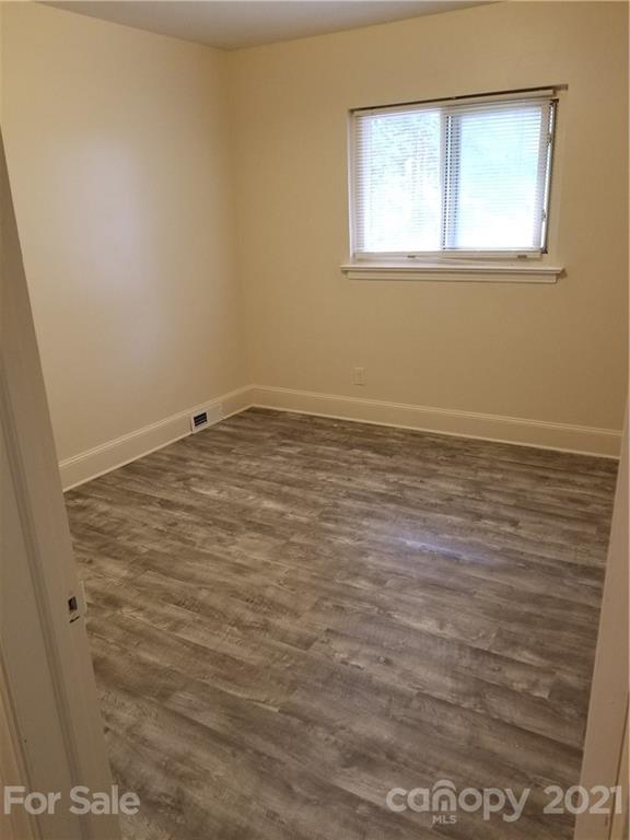 2128 North Sharon Amity Road Charlotte, NC 28212 - Photo 6 of 15 a view of an empty room with a window