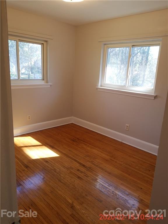 2128 North Sharon Amity Road Charlotte, NC 28212 - Photo 7 of 15 a view of empty room with wooden floor and fan