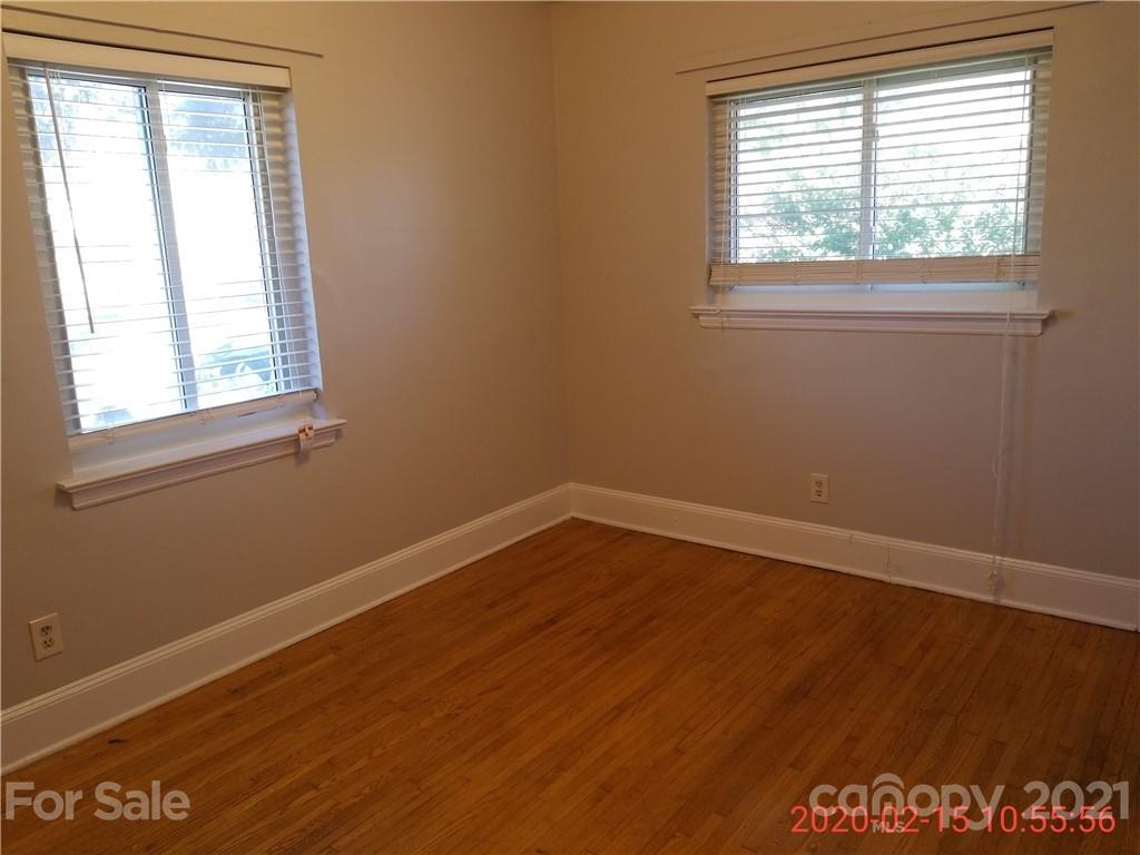 2128 North Sharon Amity Road Charlotte, NC 28212 - Photo 9 of 15 a view of an empty room with wooden floor and a window