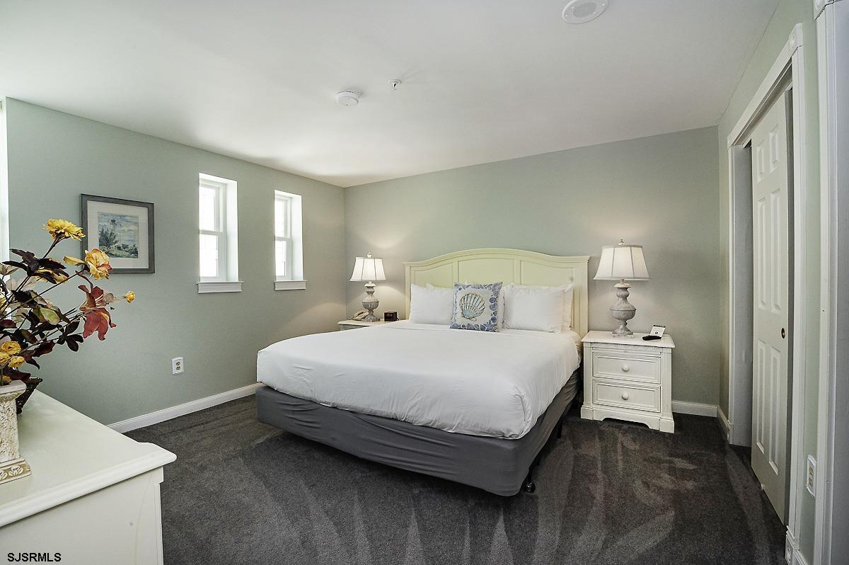 719 East 11th Street, Unit 915 Ocean City, NJ 08226 - Photo 12 of 27 a bedroom with a bed and a potted plant