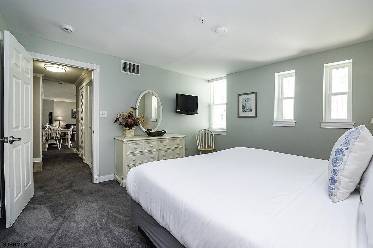 719 East 11th Street, Unit 915 Ocean City, NJ 08226 - Photo 15 of 27 a bedroom with a bed and a flat screen tv